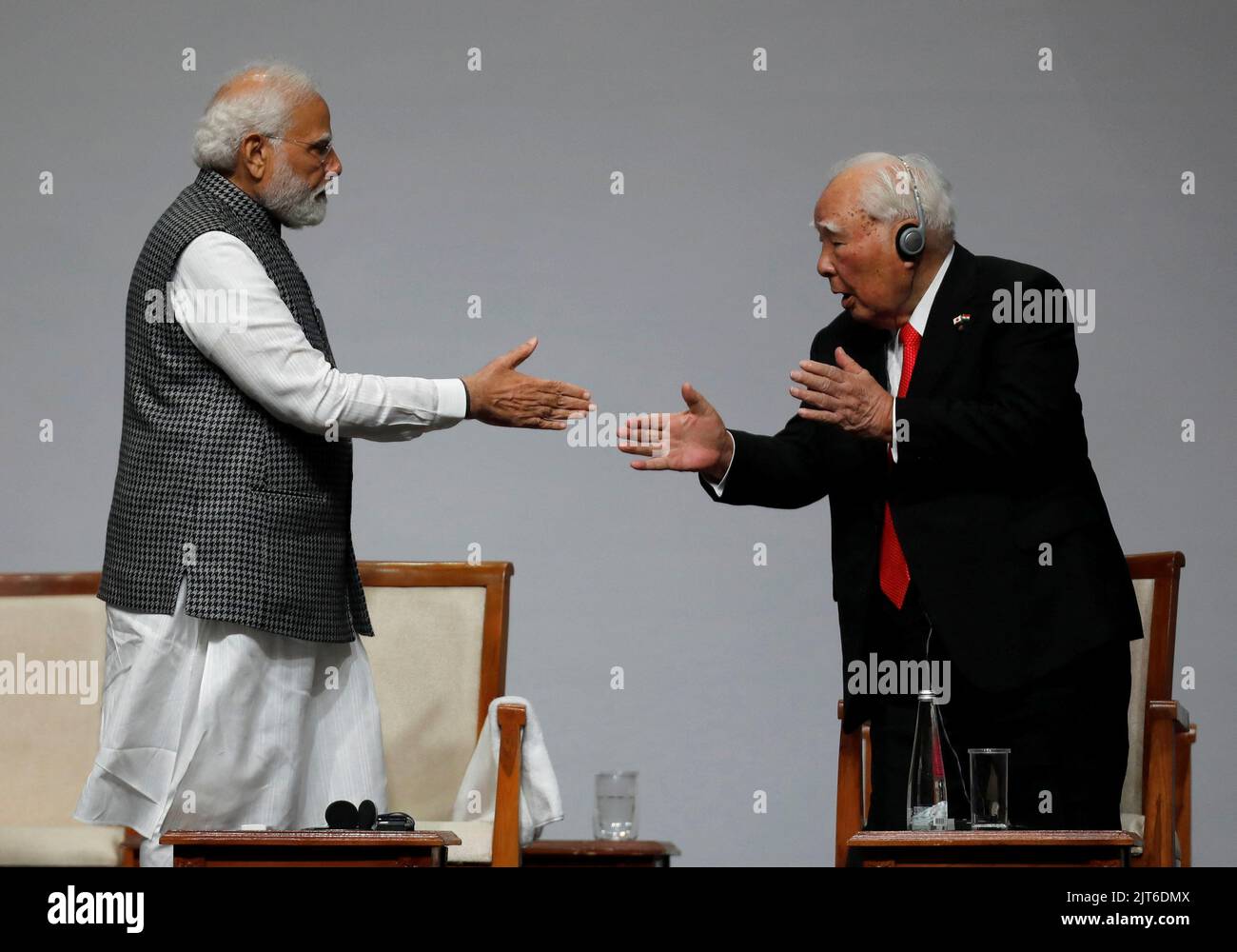India's Prime Minister Narendra Modi shakes hands with Japan's Suzuki Motor Corp former chairman Osamu Suzuki during an event to commemorate 40 years of Suzuki in India, in Gandhinagar, in the western state of Gujarat, India, August 28, 2022. REUTERS/Amit Dave Stock Photo