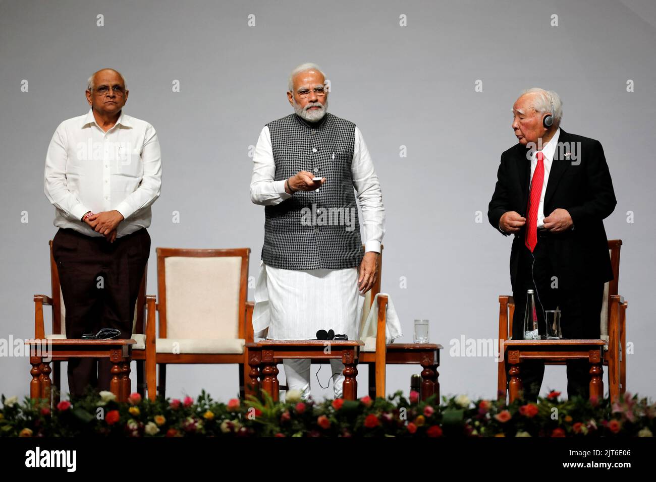 India's Prime Minister Narendra Modi lays foundation stone of Maruti's new car plant as Japan's Suzuki Motor Corp former chairman Osamu Suzuki and Chief Minister of Gujarat Bhupendra Patel look on during an event to commemorate 40 years of Suzuki in India, in Gandhinagar, in the western state of Gujarat, India, August 28, 2022. REUTERS/Amit Dave Stock Photo