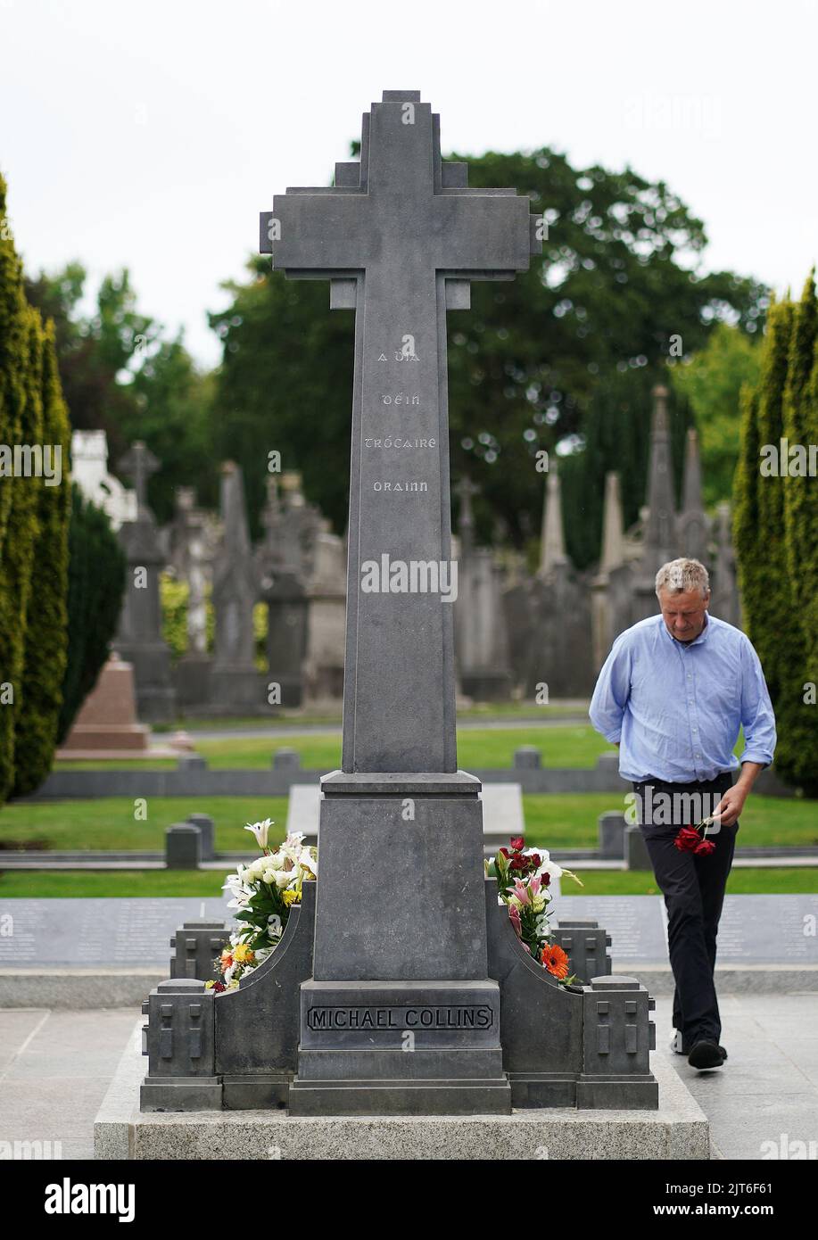 Fintan Lalor, from Co. Laois, places flowers at the grave of Michael ...