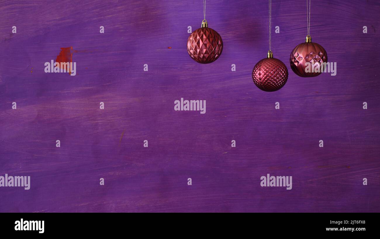 Christmas balls on purple background.Christmas template with large copy space.Negative space technique. Stock Photo