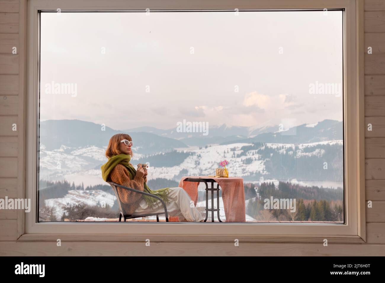 Woman on terrace at rest house in the mountains Stock Photo - Alamy