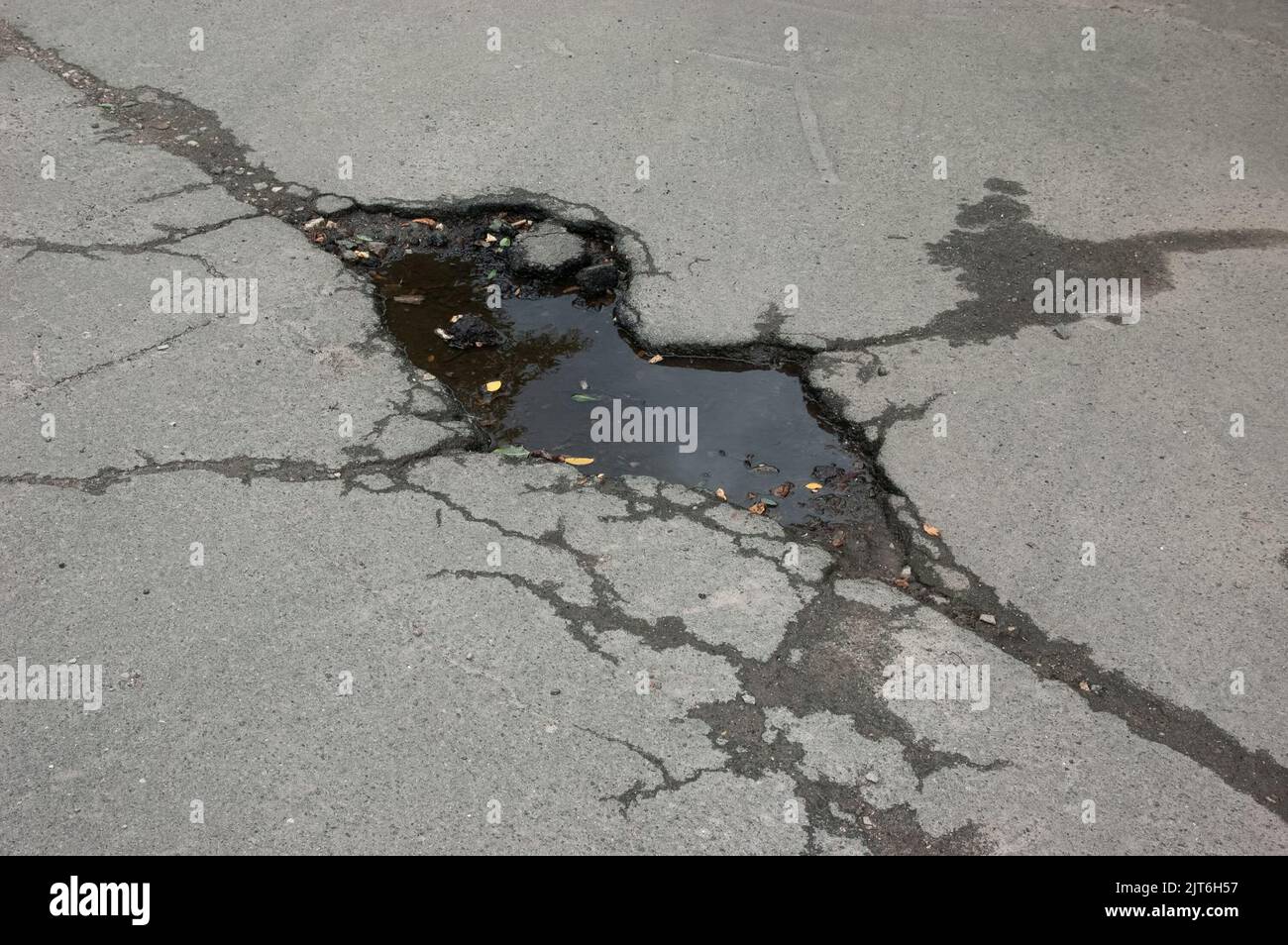 a puddle on cracked asphalt Stock Photo