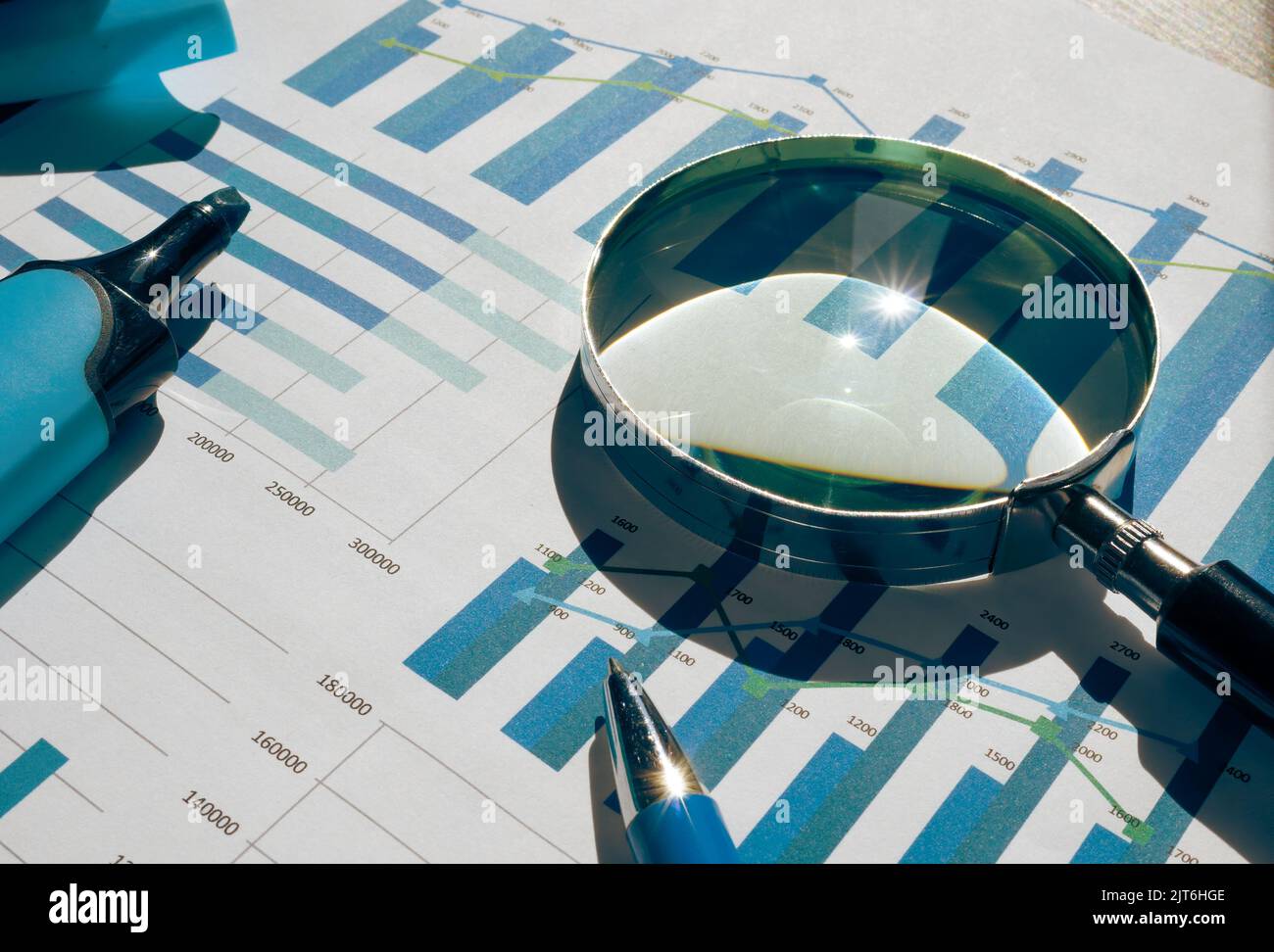 Financial charts, graphs and magnifying glass for audit. Stock Photo