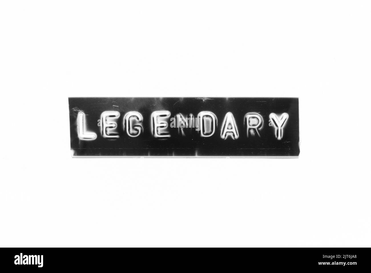 Embossed letter with word legendary in black banner on white paper