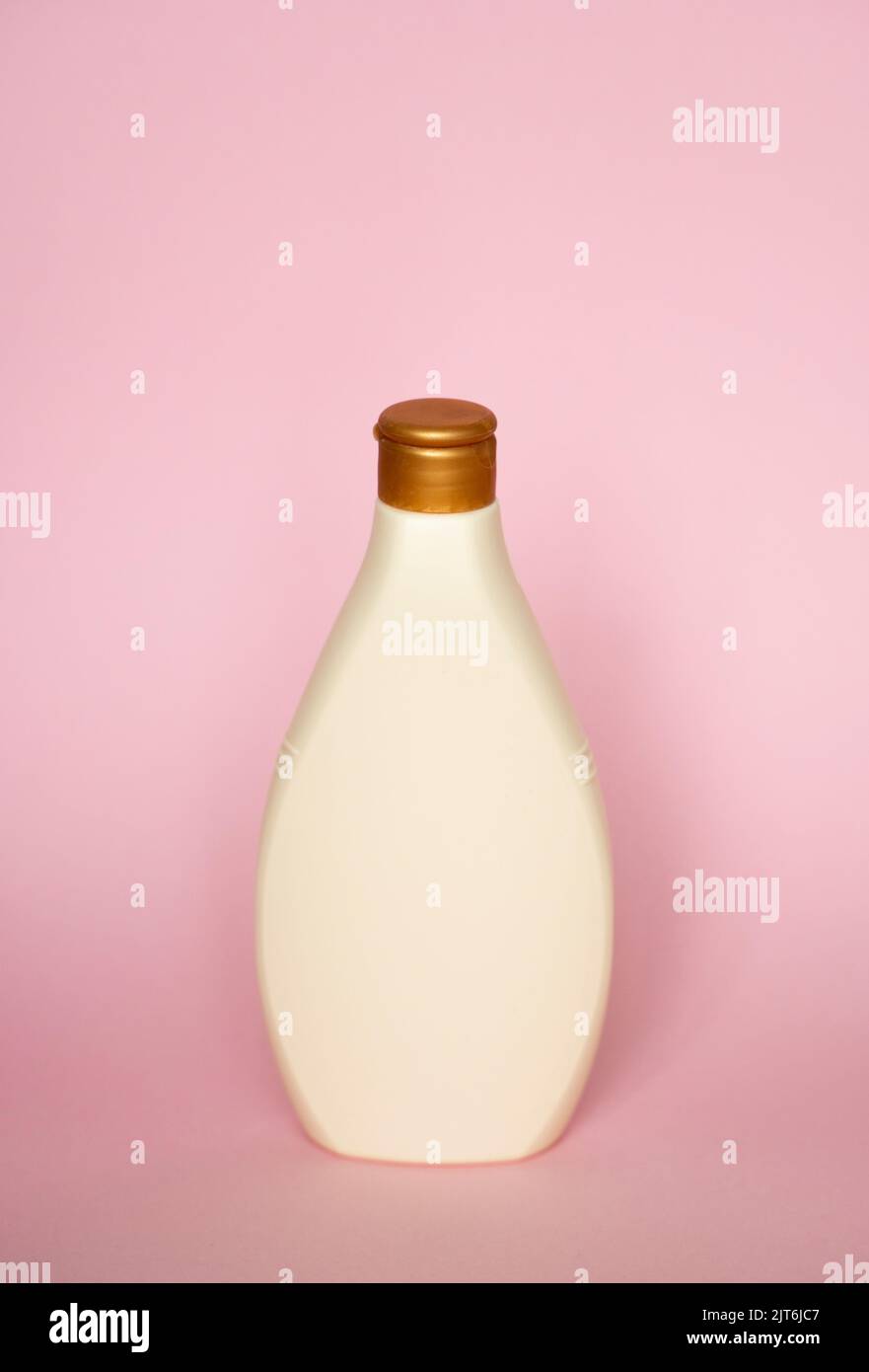 Beige blank plastic bottles isolated on pink background. Stock Photo