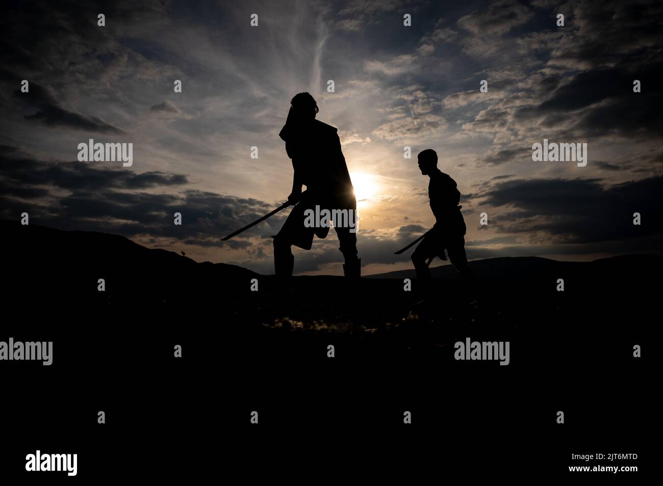 Martial arts sword fighting silhouettes at sunset Stock Photo Alamy