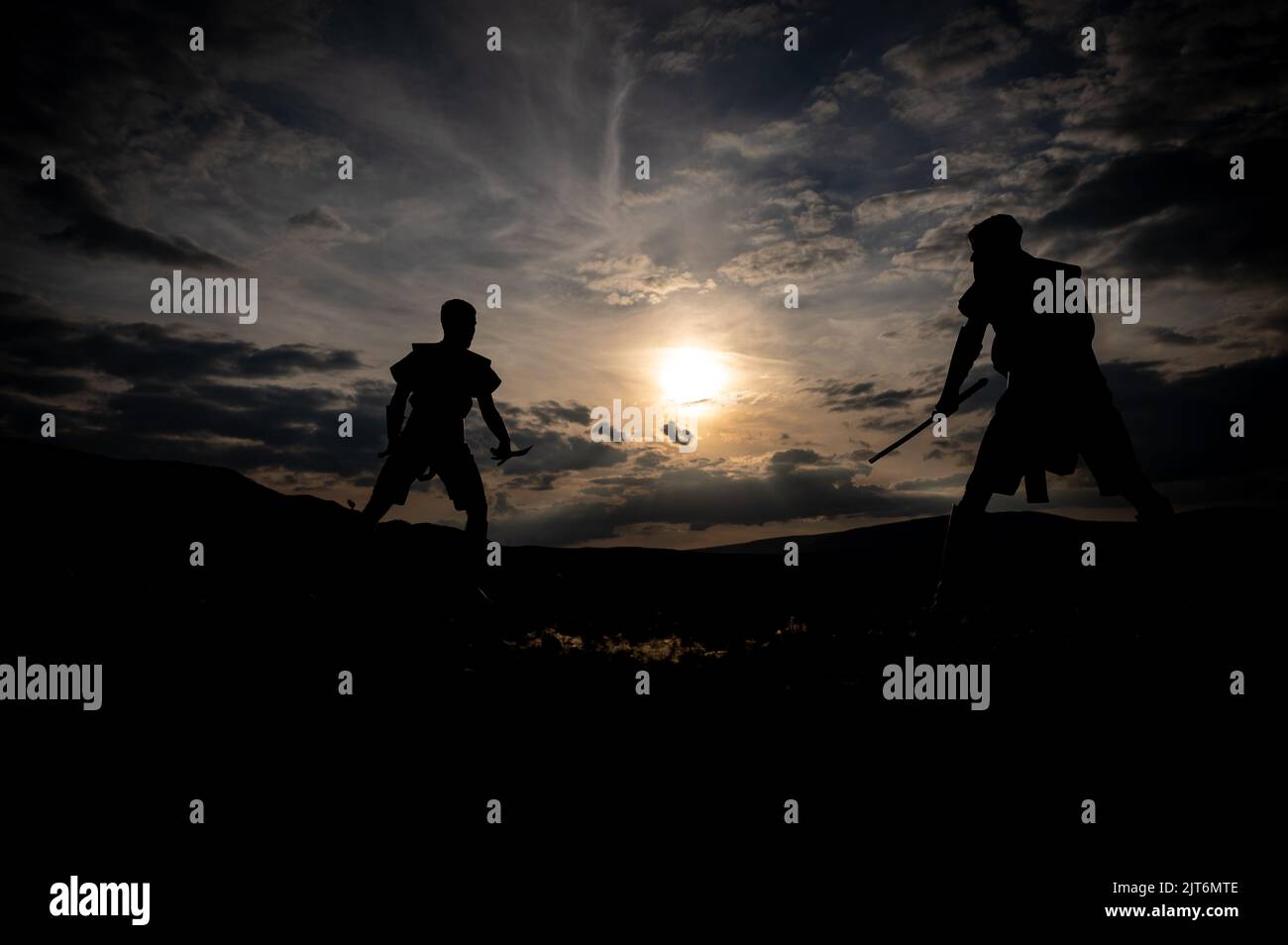 Martial arts sword fighting silhouettes at sunset Stock Photo