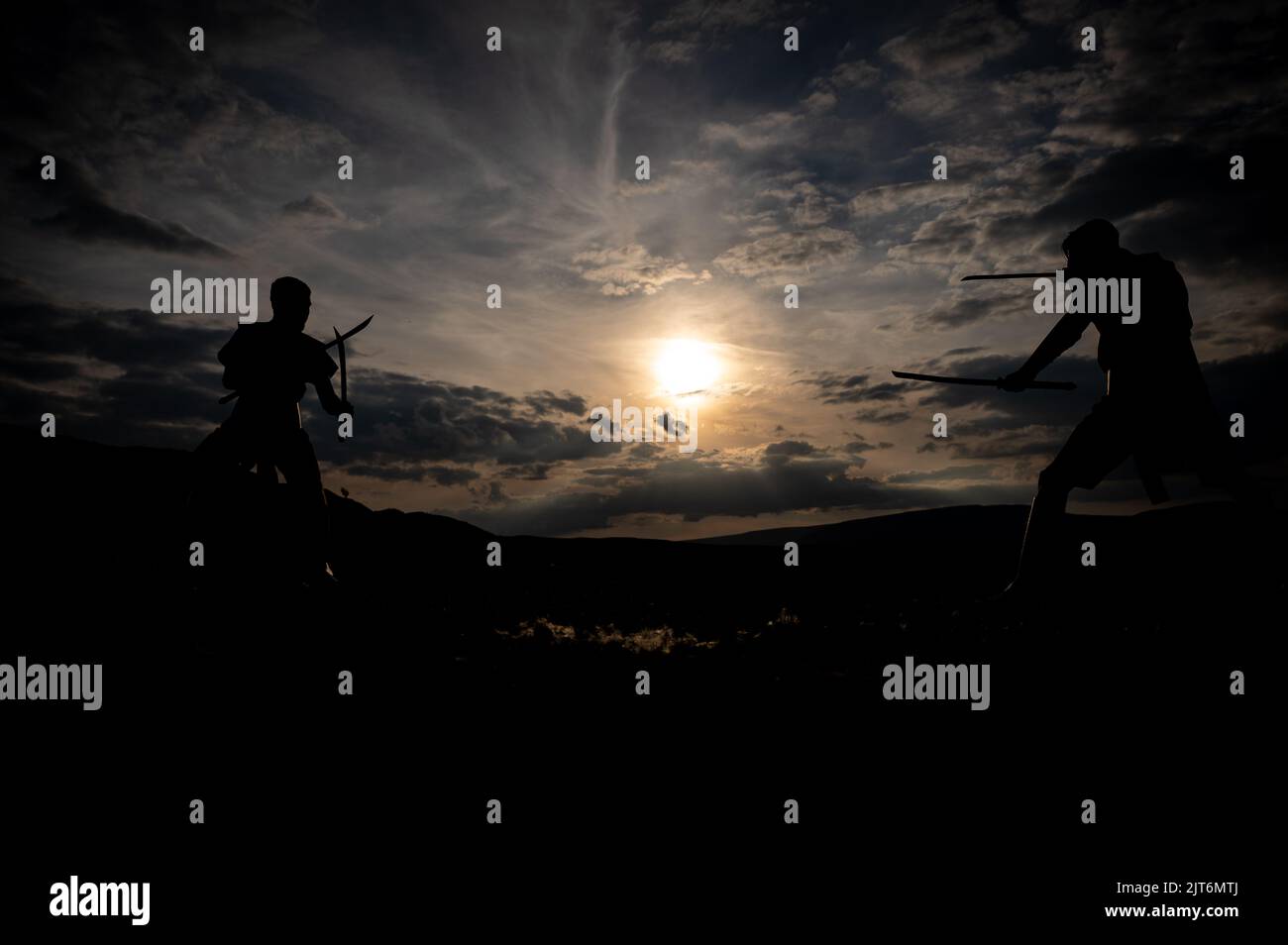 Martial arts sword fighting silhouettes at sunset Stock Photo Alamy