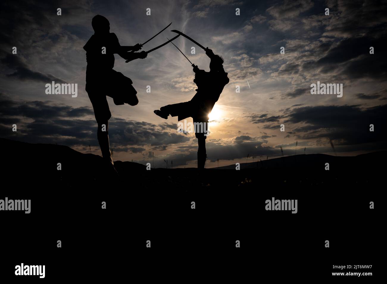 Martial arts sword fighting silhouettes at sunset Stock Photo Alamy