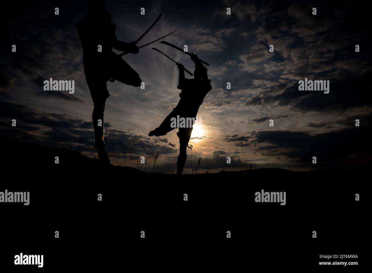 Martial arts sword fighting silhouettes at sunset Stock Photo Alamy