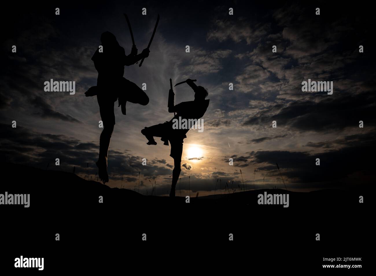 Martial arts sword fighting silhouettes at sunset Stock Photo Alamy