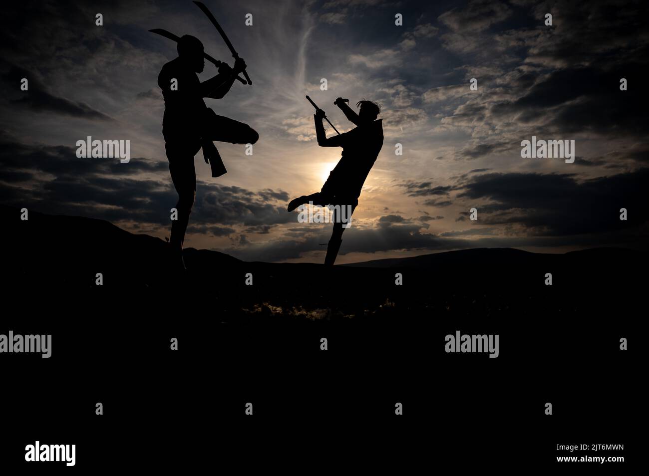 Martial arts sword fighting silhouettes at sunset Stock Photo Alamy