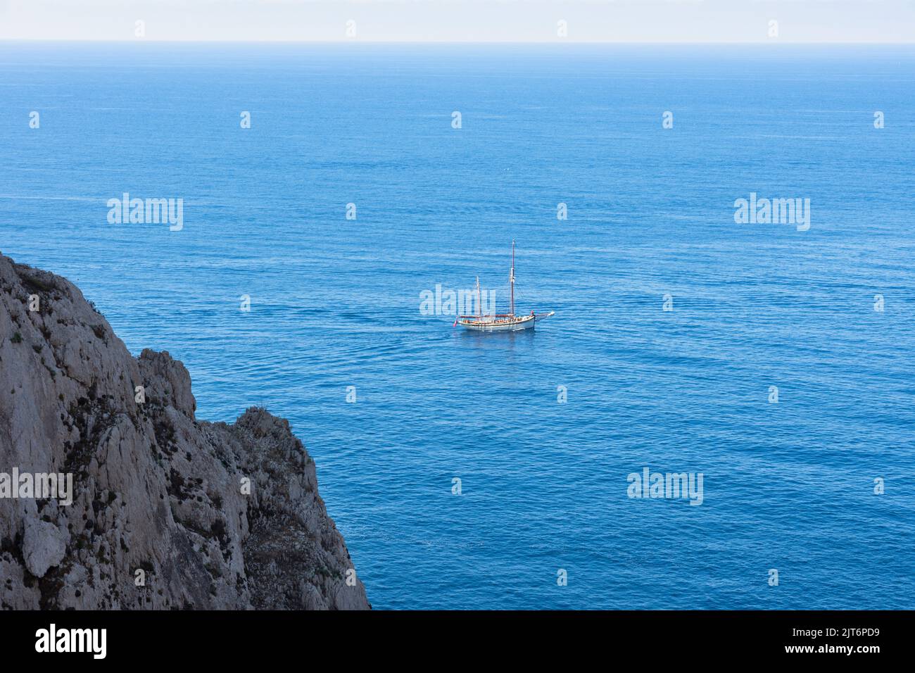 Horizontal view from a sailboat gorge with a turquoise Mediterranean Sea and blue sky on the horizon. Stock Photo