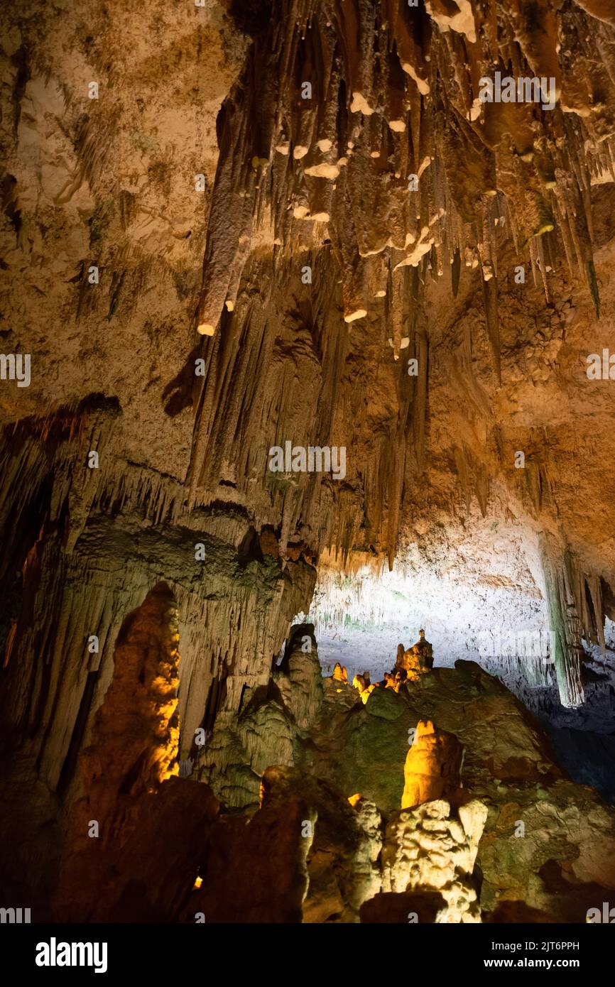 Horizontal view of the ceiling and floor of a salt sea cave, Mediterranean, with a close-up of stalagtites and stalagmites. Stock Photo