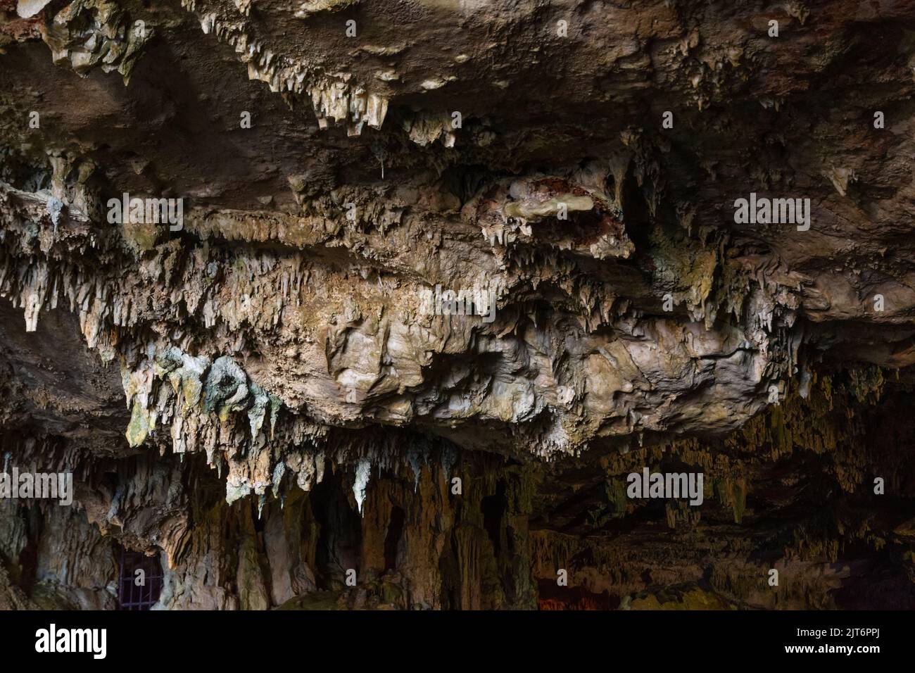 Horizontal view of the ceiling of a salty sea cave, Mediterranean, with a close-up view of the stalagtites. Stock Photo