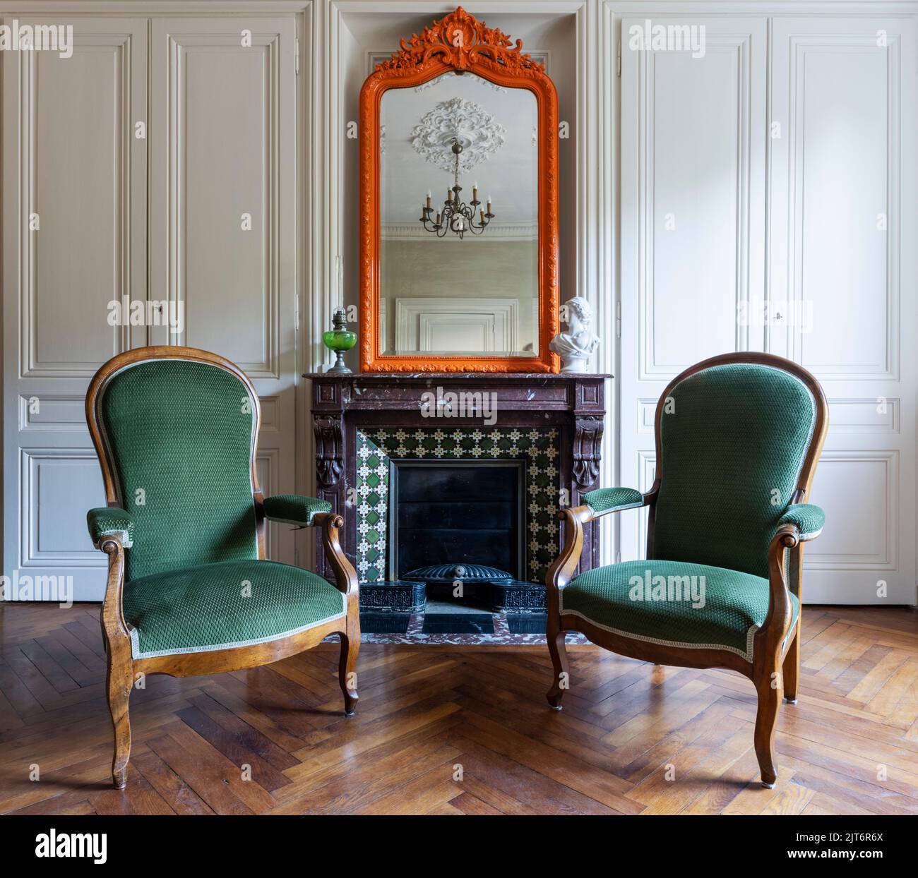 Two armchairs in front of fireplace in a living room, France Stock Photo
