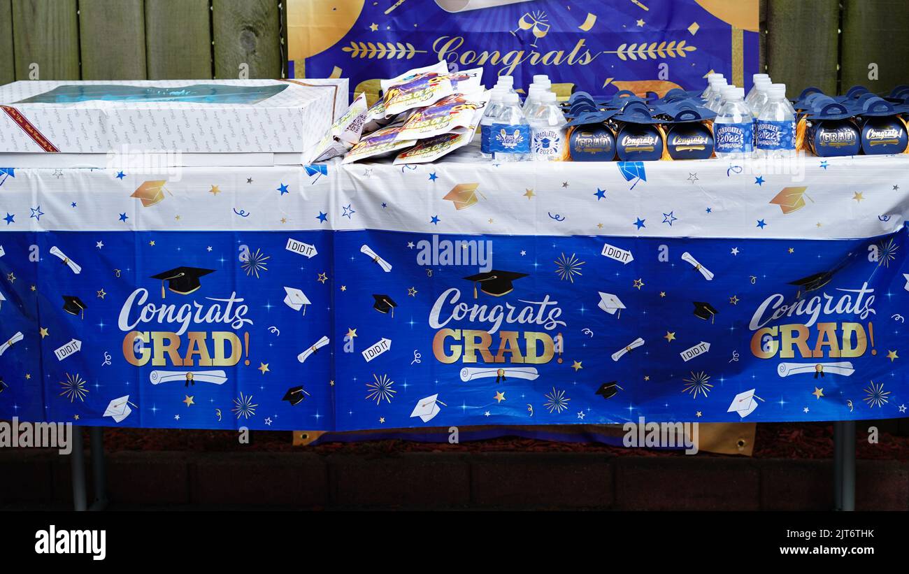 A table with blue high school graduation party decorations for the celebration Stock Photo