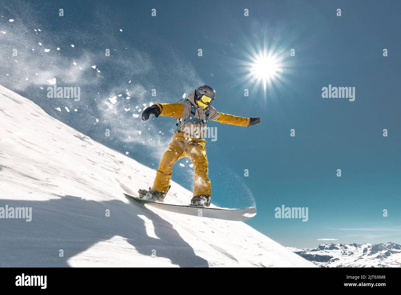Real snowboarder jumps at alpine offpiste ski slope. Winter sports concept Stock Photo