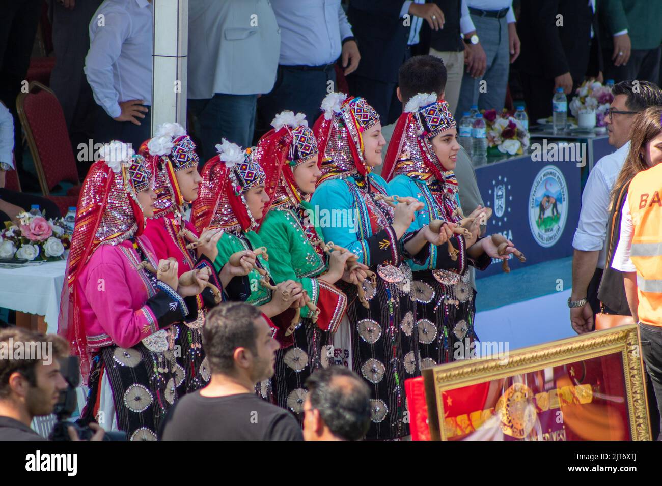 Bursa, Turkey - August 2022: Traditional Turkish oil wrestling festival, Female folk dance team applauding the wrestlers in traditional folklore costumes. Selective focus. Stock Photo