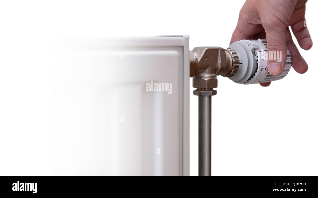 Hand turns the thermostatic tap to turn the heating down. Isolated on white with heating