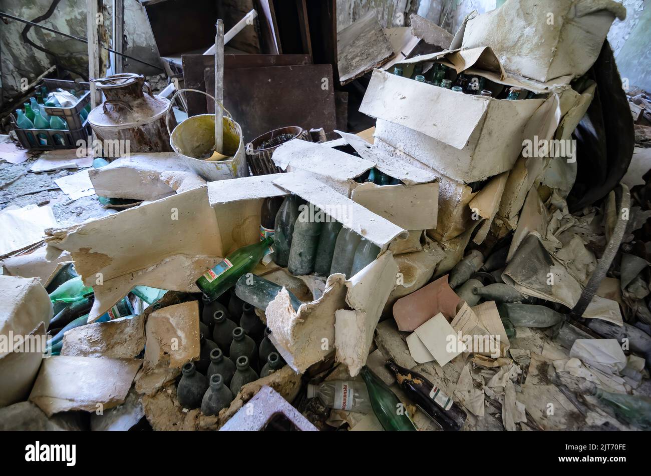 Details of the Chernobyl fire station left right after the disaster. Old empty bottles in boxes in the foreground Stock Photo