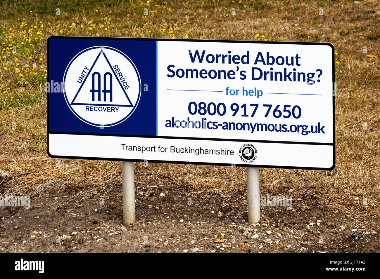 Roadside alcoholics-anonymous sign asking if worried about someone's drinking make contact with the AA. Stock Photo