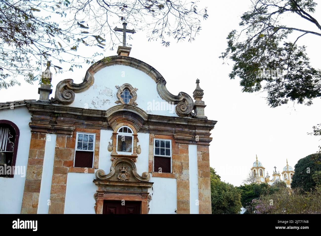 Tiradentes, Minas Gerais, Brazil - August 6, 2022: Church of Our Lady of the Rosary detail and church of Saint Antonio in the background in the city h Stock Photo
