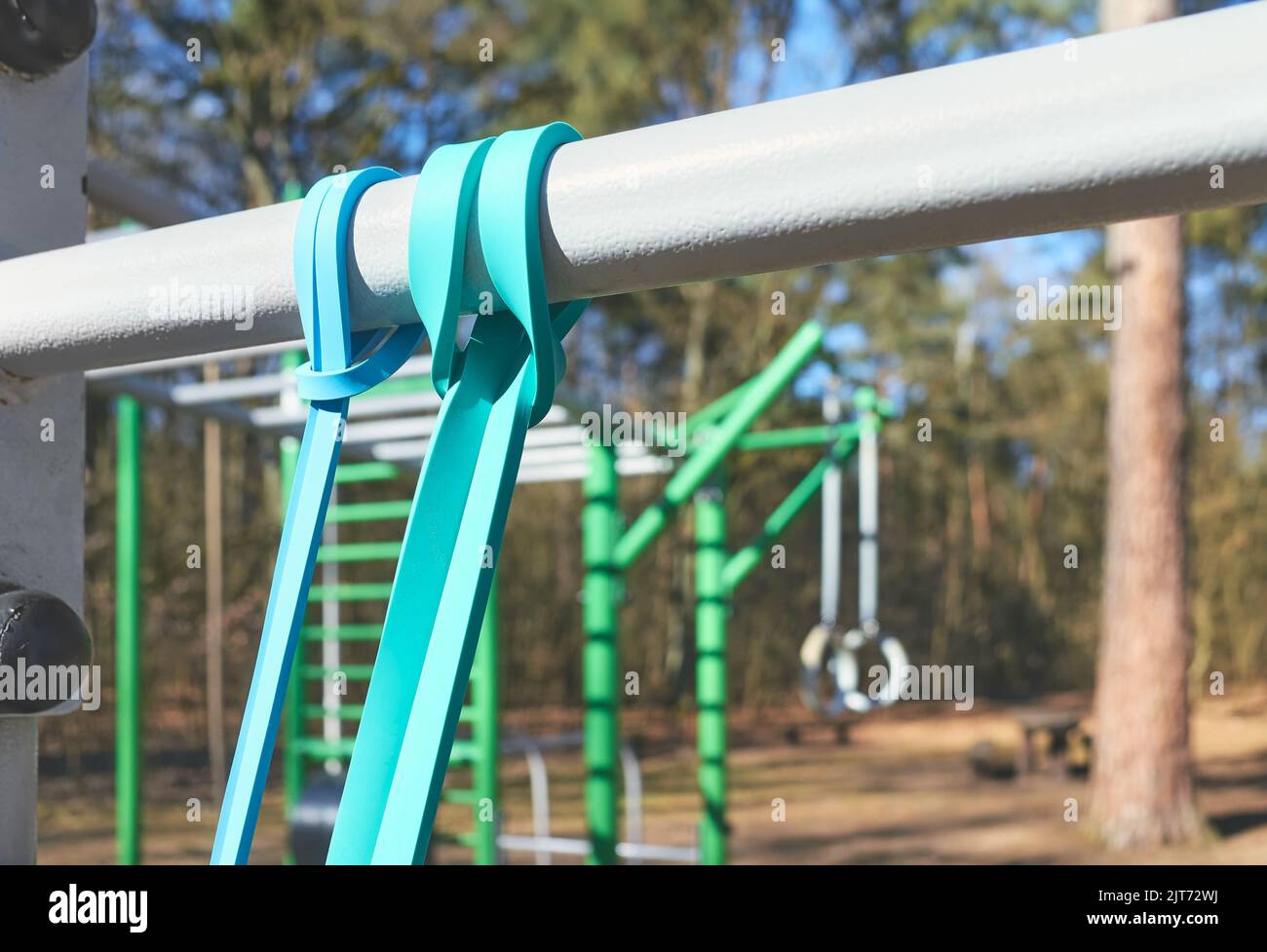 Close up picture of resistance bands on bar at an outdoor gym, selective focus. Stock Photo