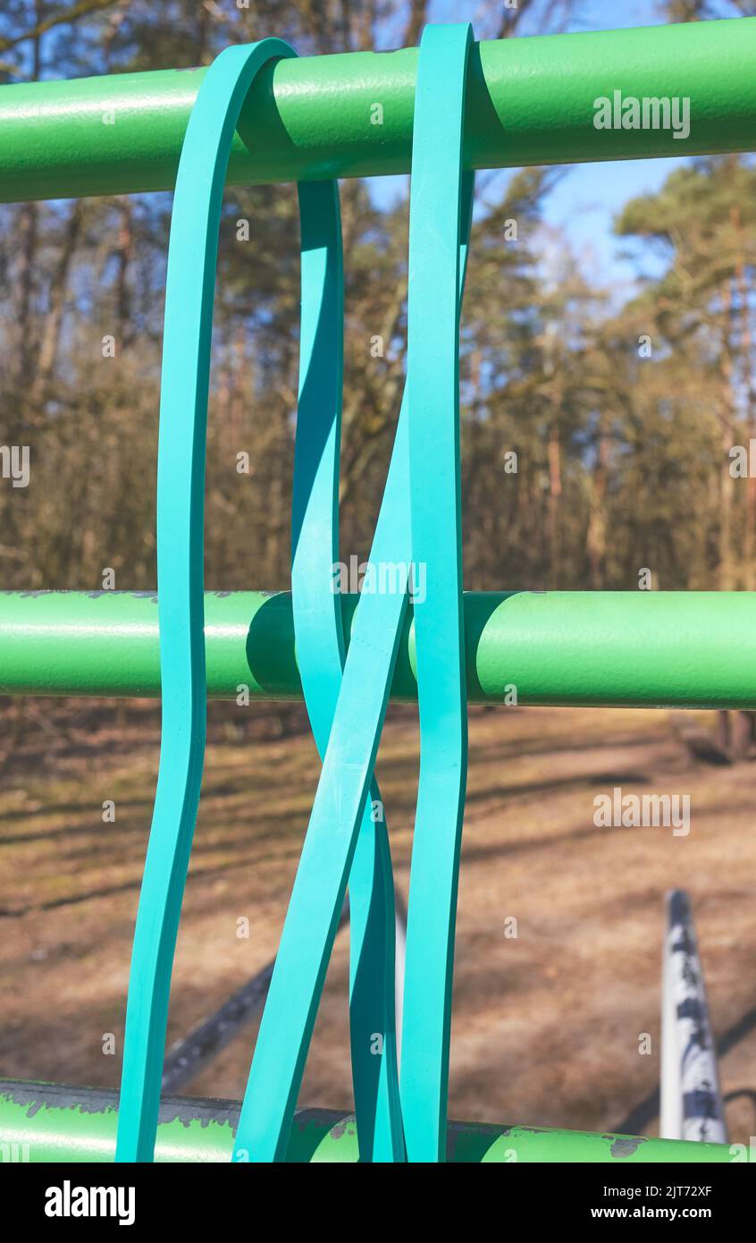 Close up picture of resistance band on bar at an outdoor gym, selective focus. Stock Photo