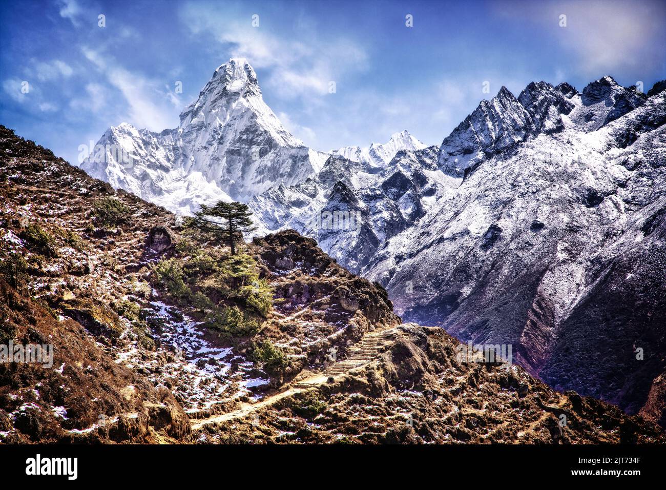 Ama Dablam (6856 meters) dominates the skyline along the trail into the high Himalaya.  Sagarmatha National Park, Nepal. Stock Photo