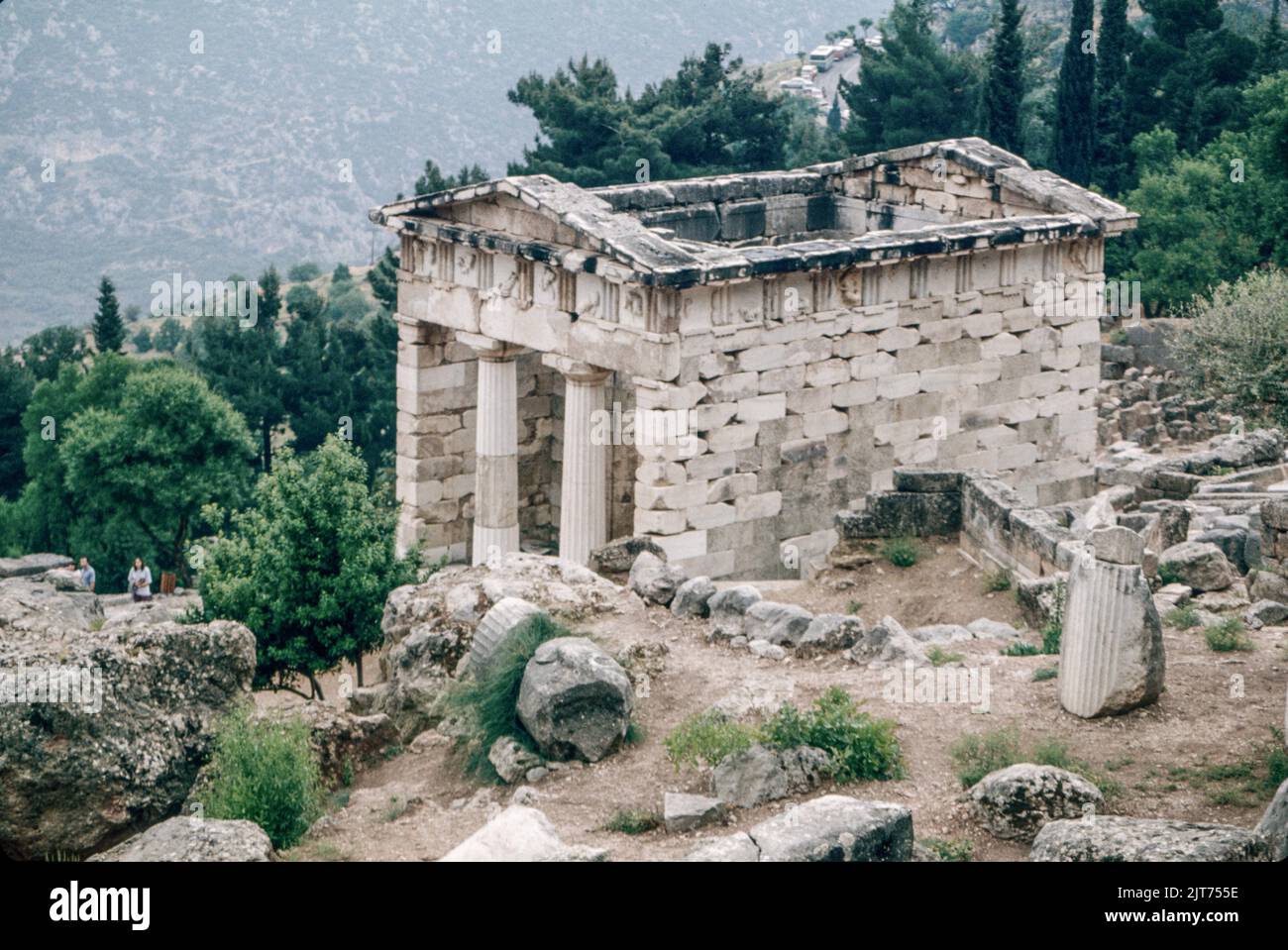 March 1980. Archival scan from a slide. Treasury of the Athenians, built to commemorate their victory at the Battle of Marathon. Delphi, ancient town and seat of the most important Greek temple and oracle of Apollo in the territory of Phocis on the steep lower slope of Mount Parnassus, about 6 miles (10 km) from the Gulf of Corinth. Delphi is now a major archaeological site with well-preserved ruins. Stock Photo