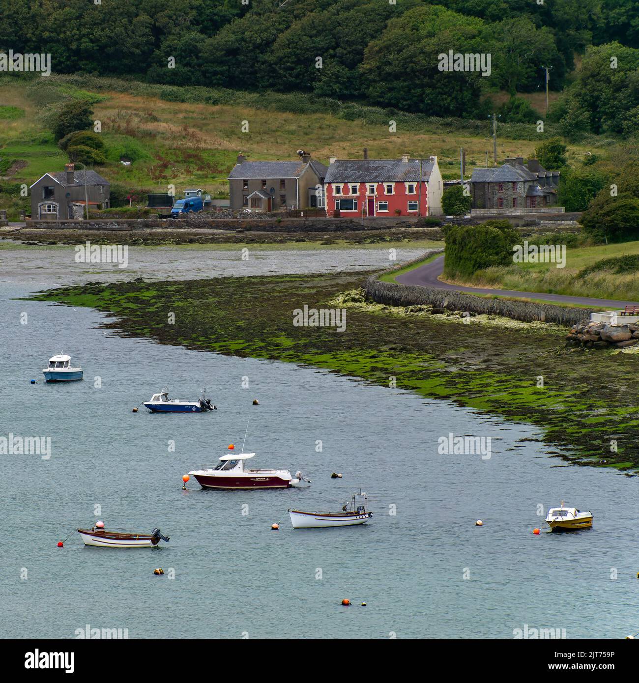 Clonakilty, Ireland, July 2, 2022. Several small boats are anchored in Clonakilty Bay at low tide. Shallow sea water. Coastal Irish landscape. Stock Photo