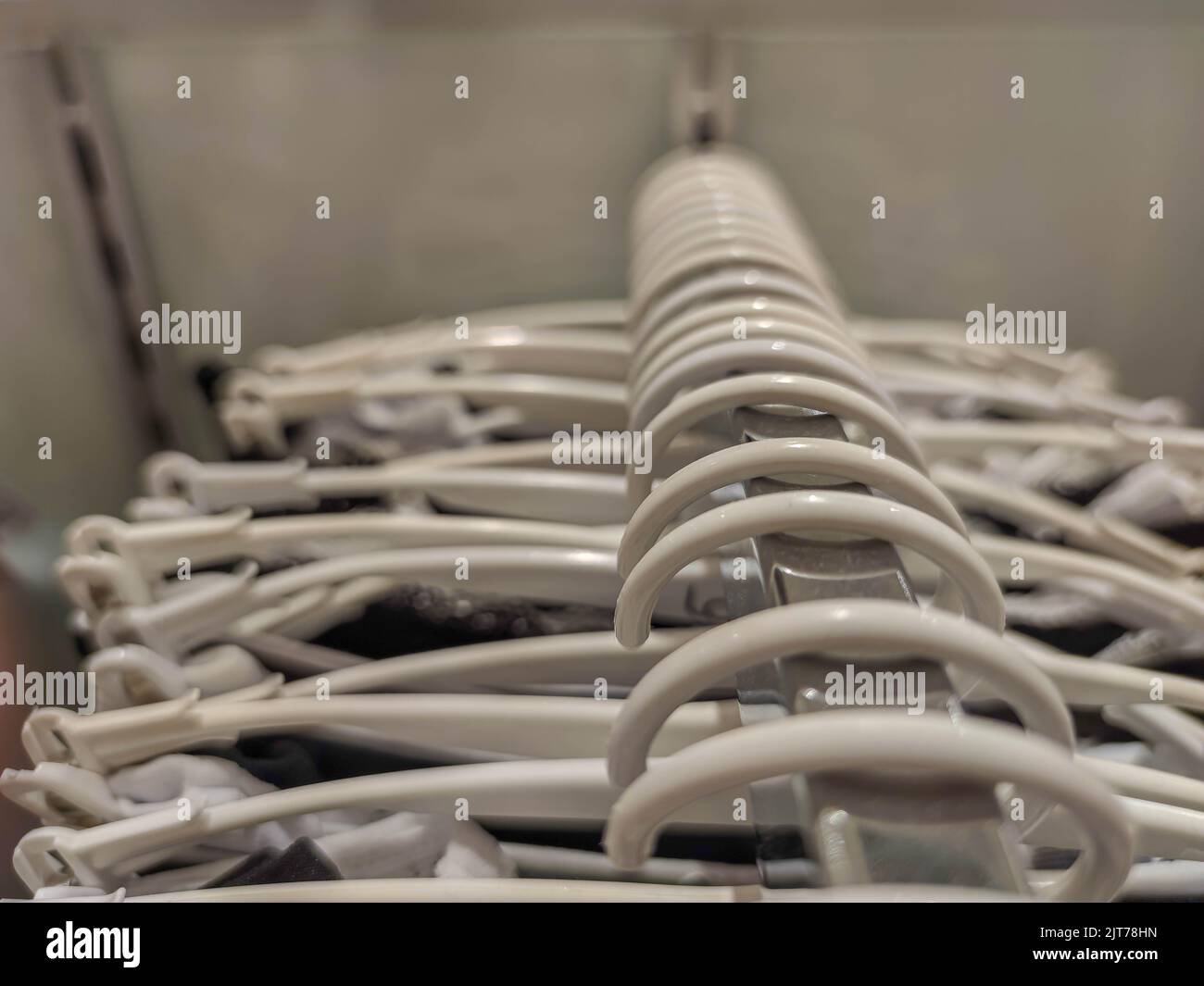 Coat racks in a department store. Clothing sale store material. Utensils for displaying fashion