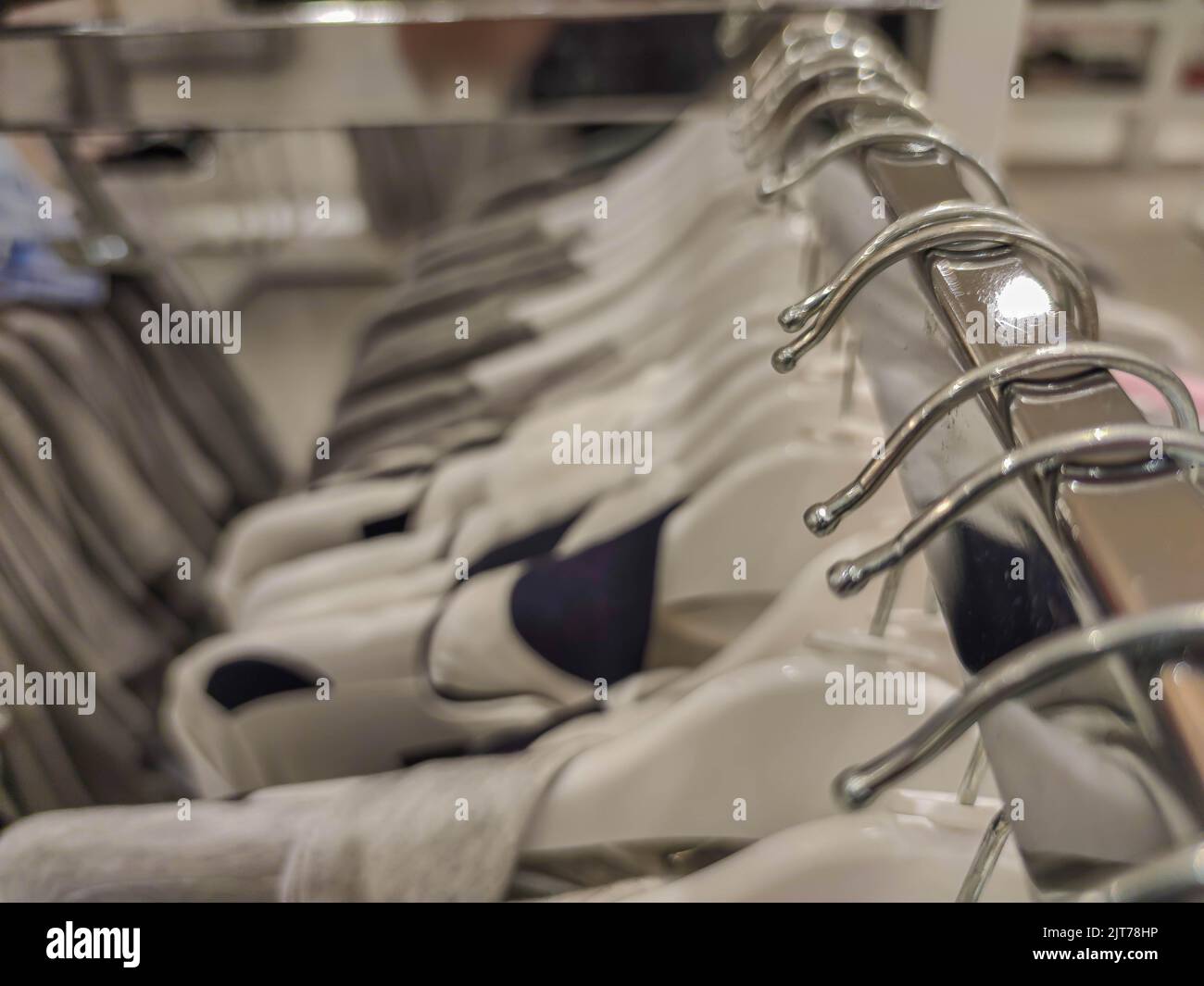 Coat racks in a department store. Clothing sale store material