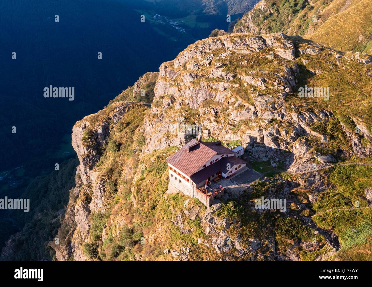 Aerial view of Rifugio Merelli al Coca on a cliff overlooking Valbondione town. Valbondione, Seriana Valley, Lombardy, Bergamo province, Italy. Stock Photo