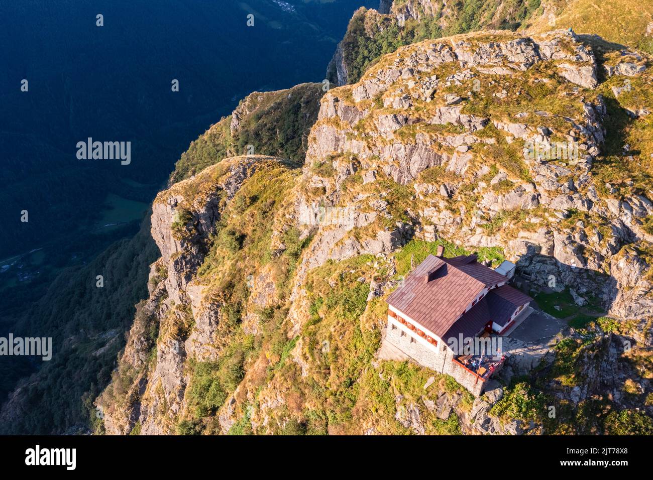 Aerial view of Rifugio Merelli al Coca on a cliff overlooking Valbondione town. Valbondione, Seriana Valley, Lombardy, Bergamo province, Italy. Stock Photo