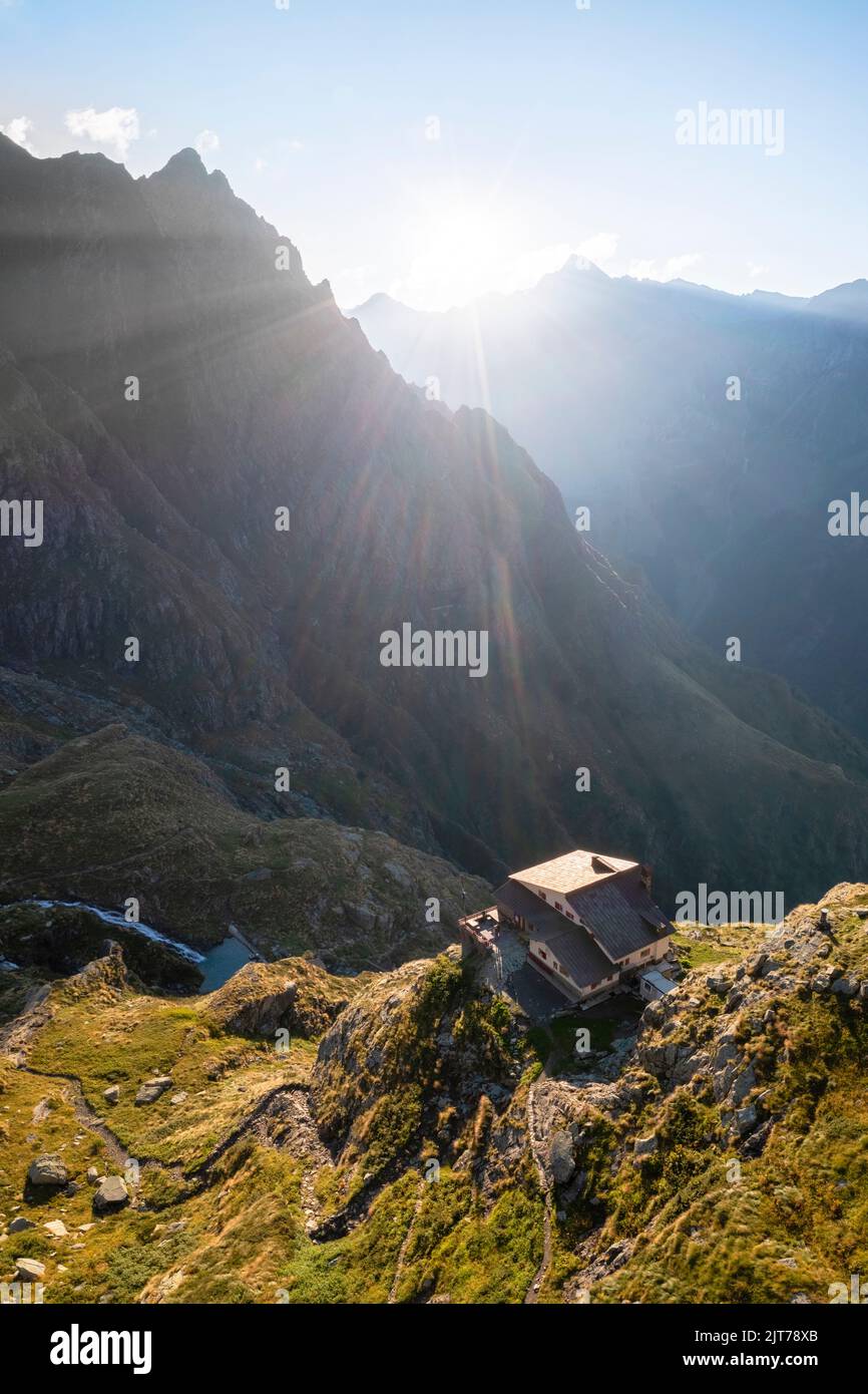 Aerial view of Rifugio Merelli al Coca on a cliff overlooking Valbondione town. Valbondione, Seriana Valley, Lombardy, Bergamo province, Italy. Stock Photo