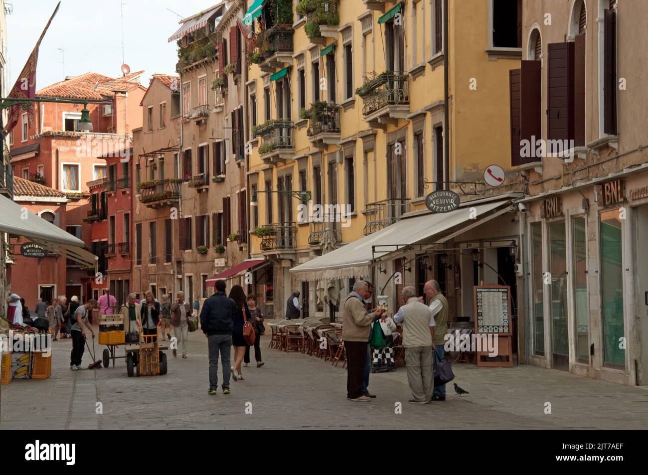 Street scene, Venice Italy. typical Venetian houses, pavement cafe, passersby Stock Photo