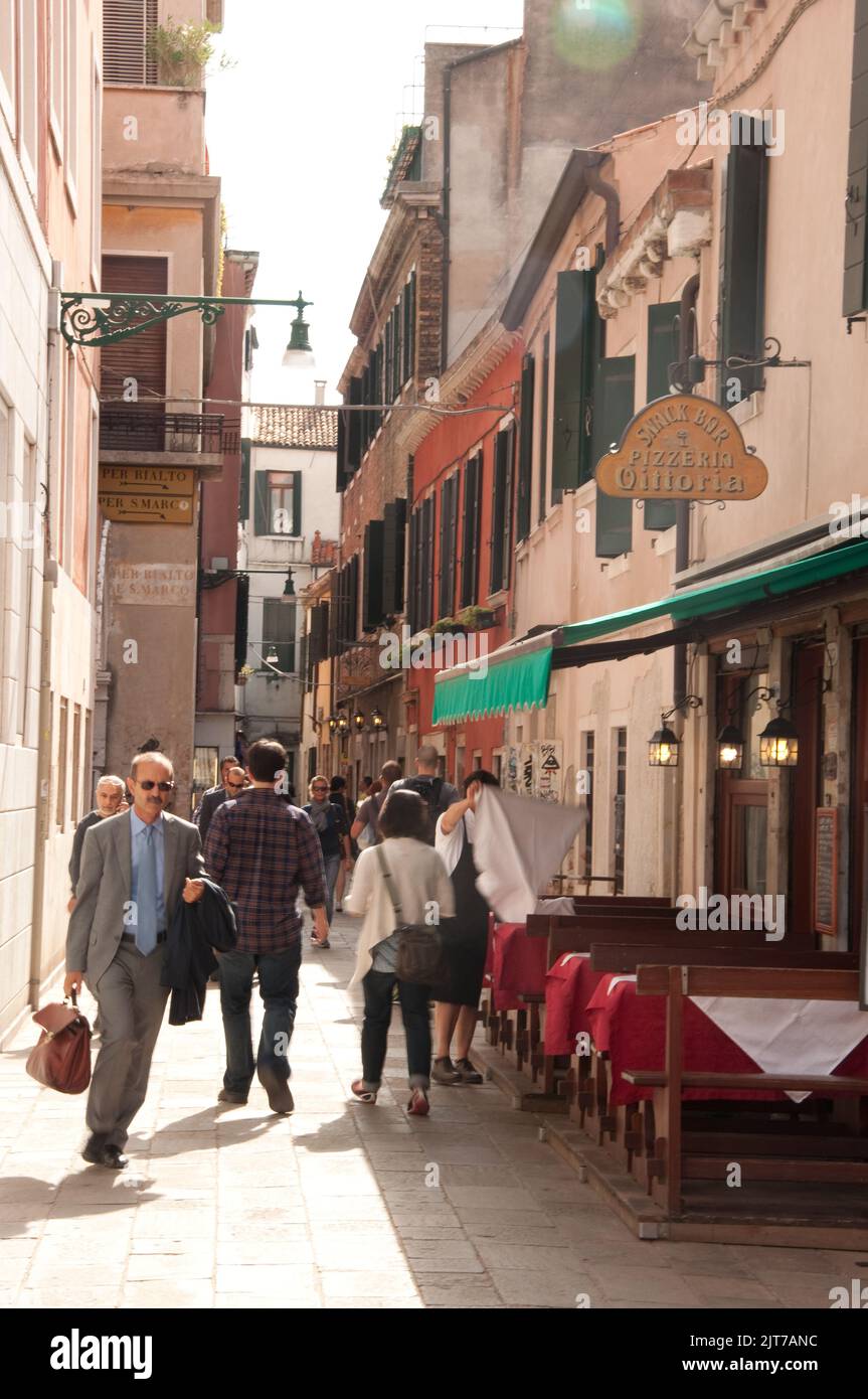 Street scene, Venice Italy. typical Venetian houses, pavement cafe, passersby Stock Photo