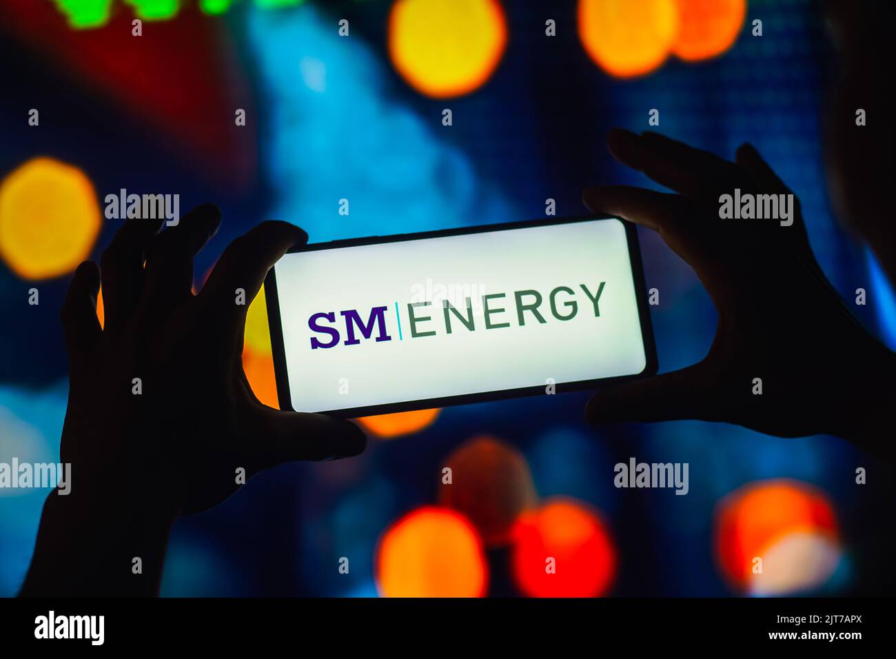 In this photo illustration, the SM Energy Company logo is displayed on a smartphone screen. Stock Photo