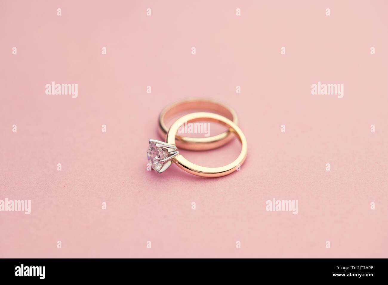 Wedding and Diamond Rings on Bright Pink Background Stock Photo - Alamy