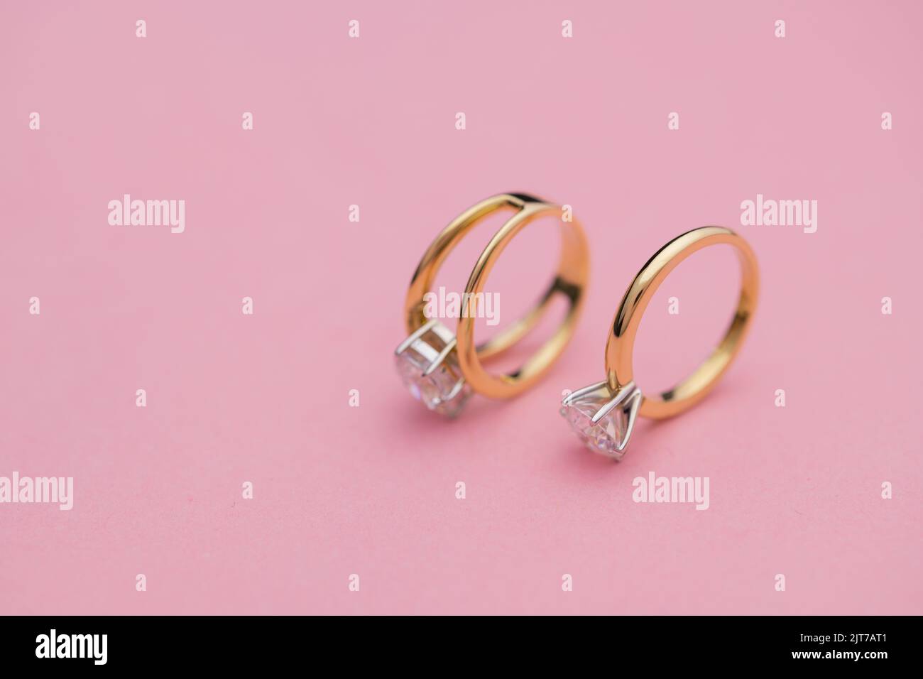 Wedding and Diamond Rings on Bright Pink Background Stock Photo - Alamy