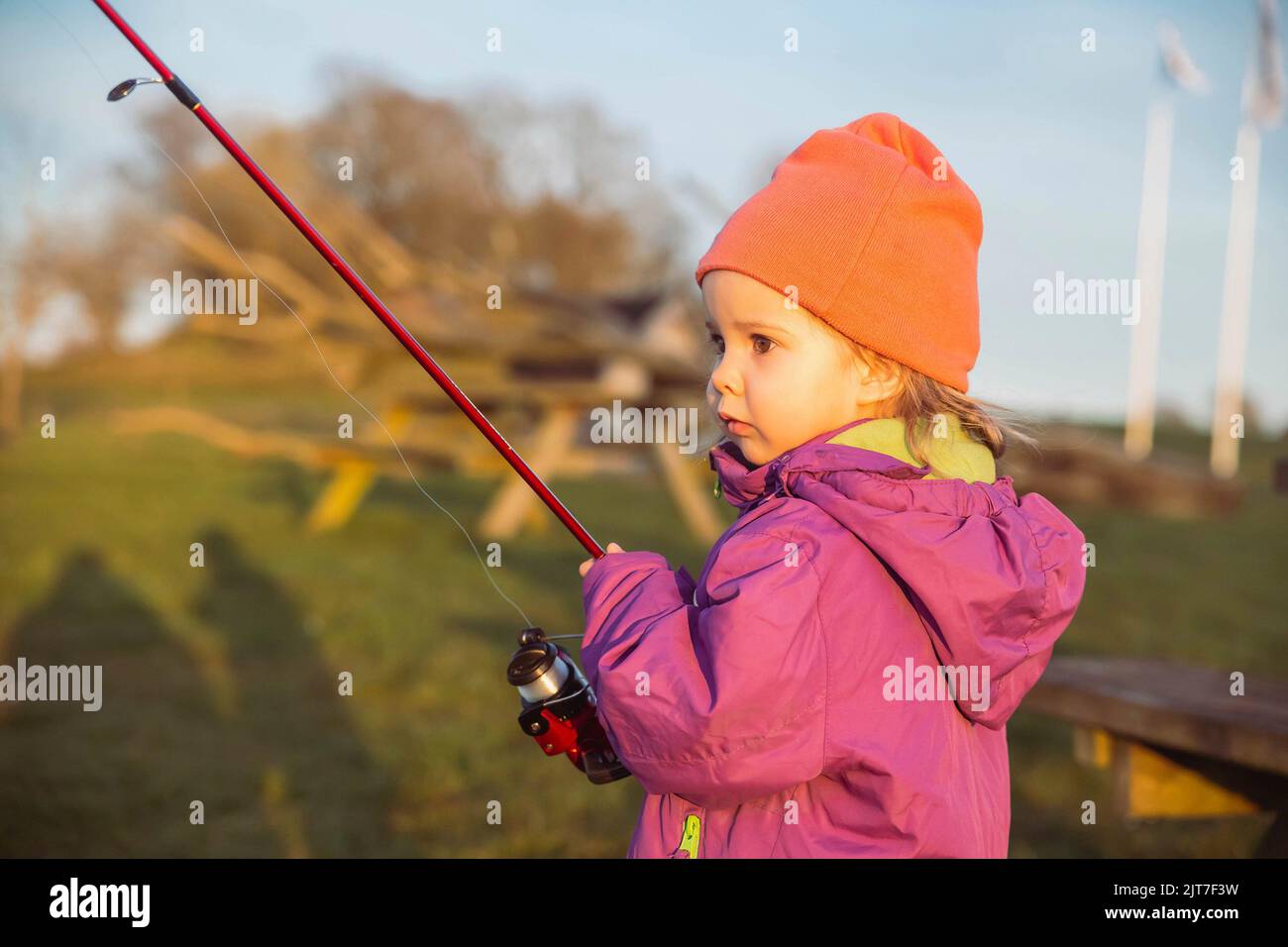 Charming baby fishing in the river at sunset Stock Photo Alamy