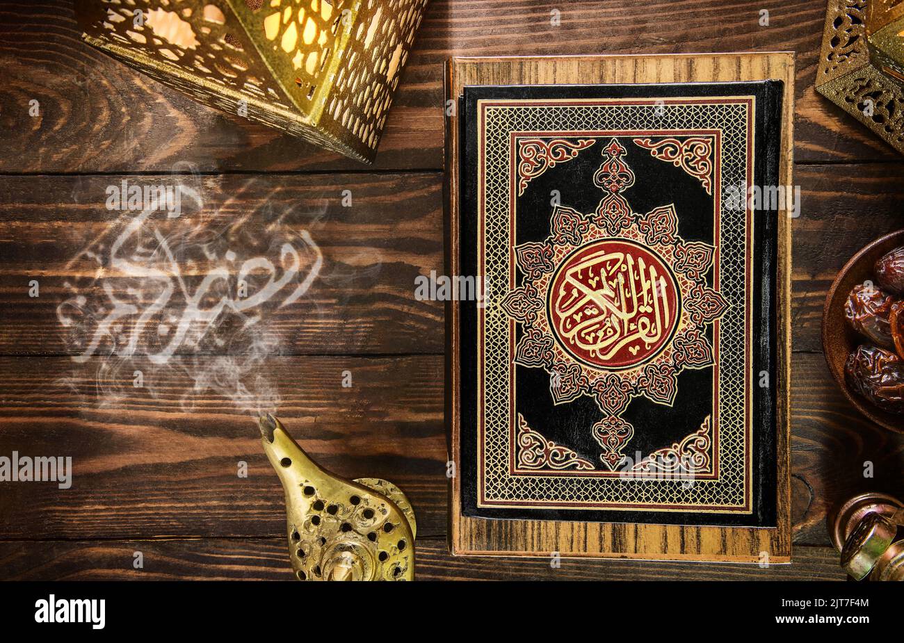 Islamic Holy Book Quran with oriental lantern. Ramadan Kareem in Arabic calligraphy style. The Arabic calligraphy means (The holy month of Muslims). Stock Photo