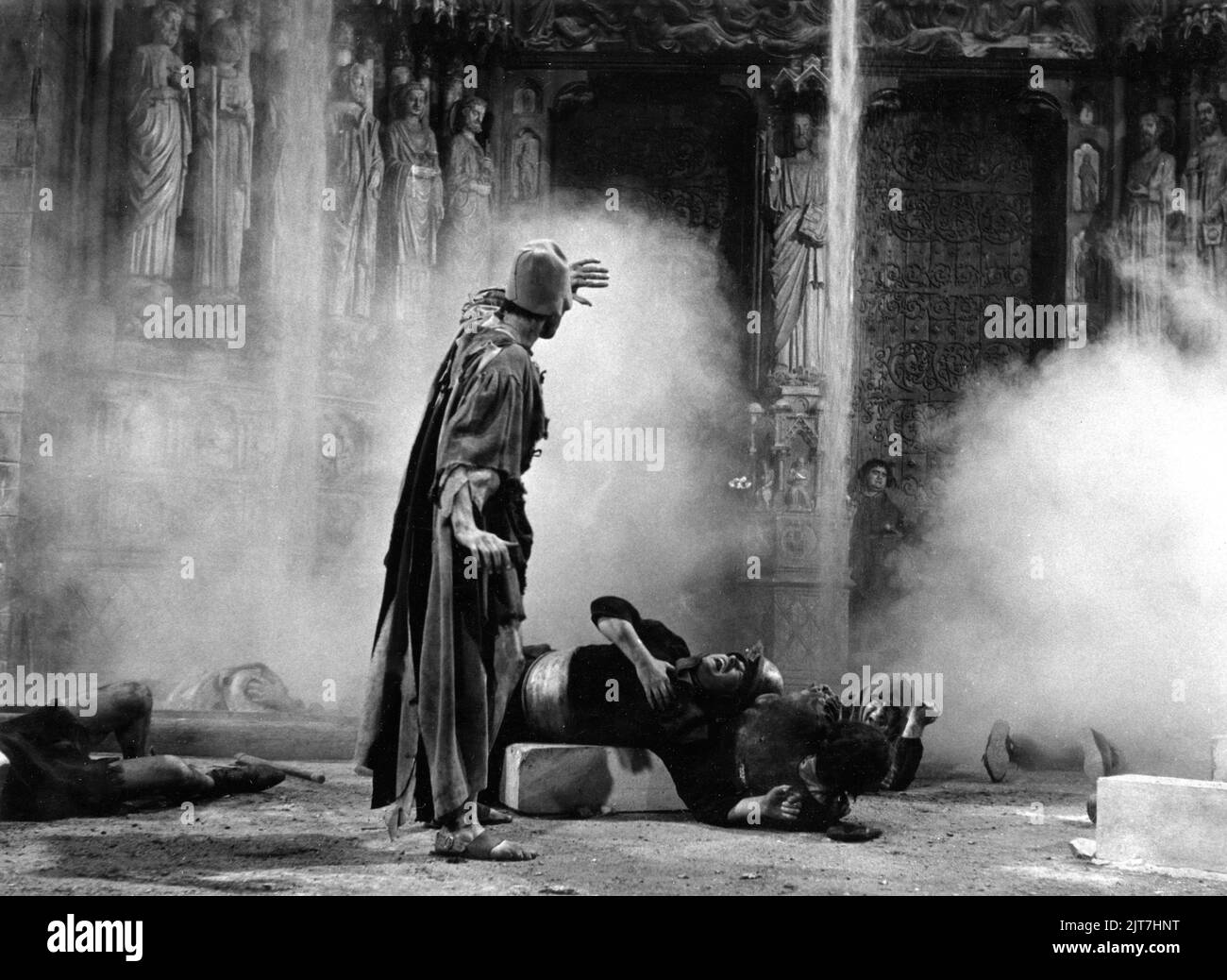 Steam from Molten Lead sprayed by Quasimodo onto Beggars outside the Cathedral in THE HUNCHBACK OF NOTRE DAME / NOTRE DAME DE PARIS 1956 director JEAN DELANNOY novel Victor Hugo adaptation / dialogue Jean Aurenche and Jacques Prevert music Georges Auric costume design Georges Benda production design Rene Renoux choreographer Leonid Massine producers Raymond and Robert Hakim France - Italy co-production Paris Film Productions / Panitalia Stock Photo