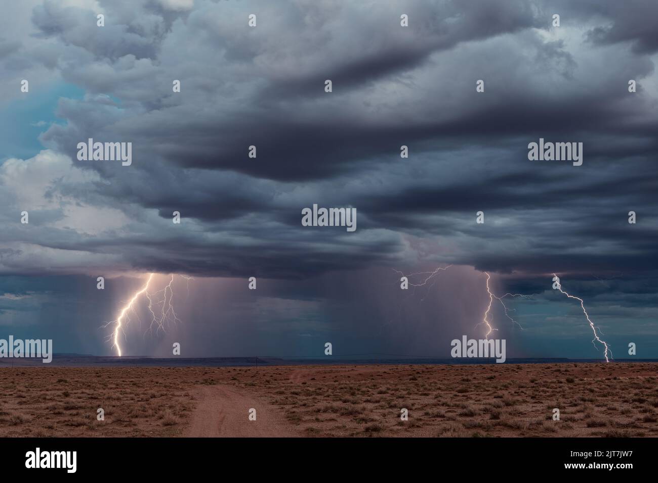 Lightning strikes from a monsoon thunderstorm over the Painted Desert in Arizona Stock Photo