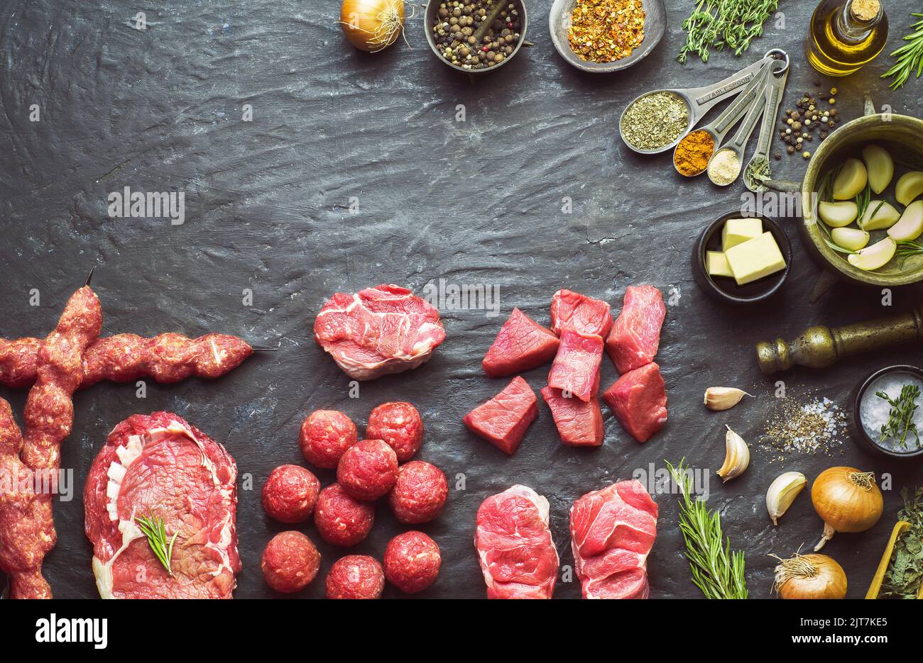 Arabic cuisine; Different types of fresh raw meat placed with fresh organic ingredients. Top view with copy space. Stock Photo