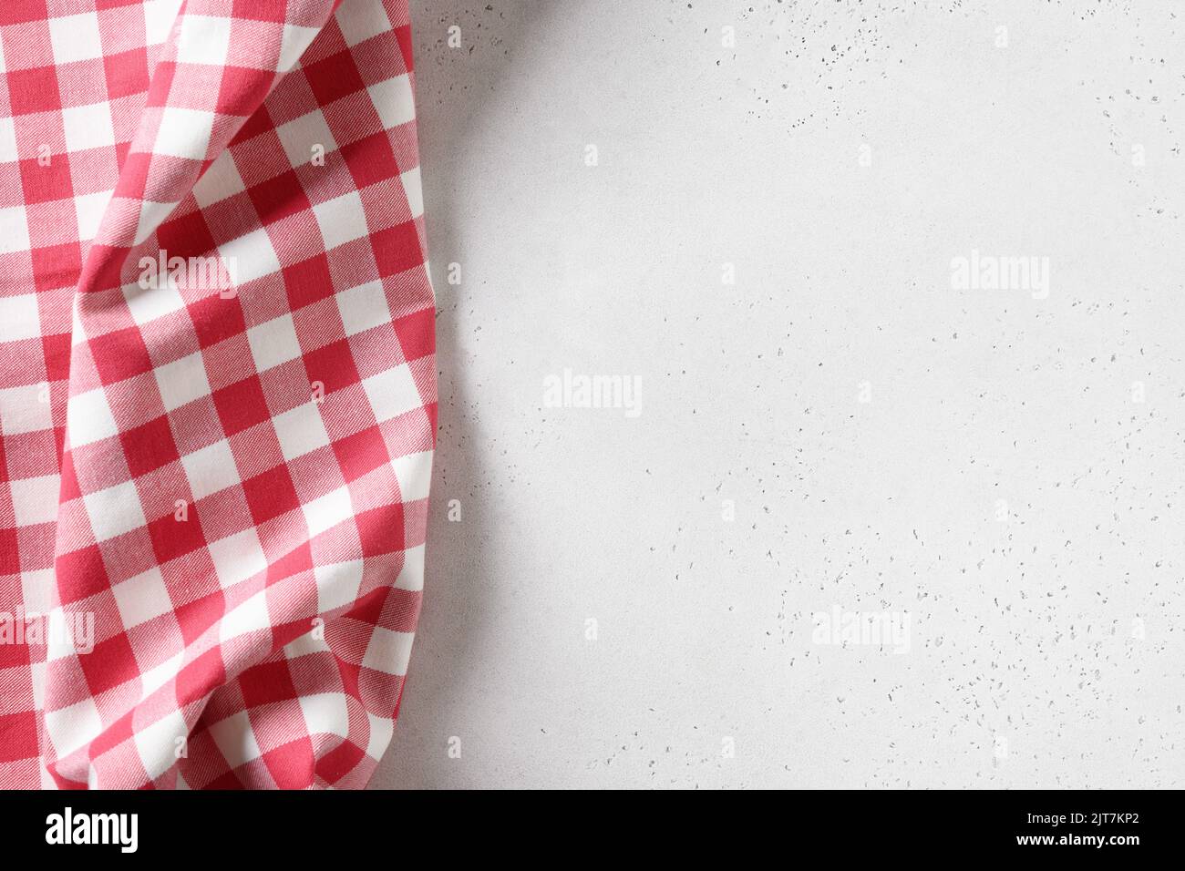 Kitchen white table with red checkered towel. Top view. Copy space. Stock Photo