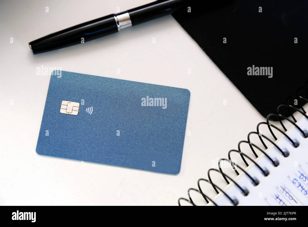 blue credit or debit contactless card with contact less sign at the work table. Digital payment system. Stock Photo