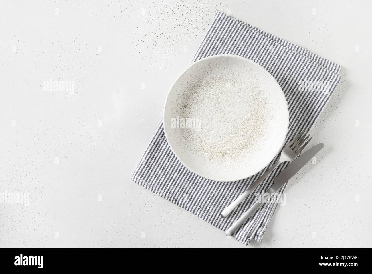White empty plate with towel on white background. Stock Photo